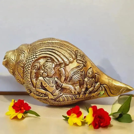 “Brass Ganesh shankh showpiece combining a curved conch form with a centered Ganesh figure, placed on a flat surface to create visual balance and subtle elegance.”