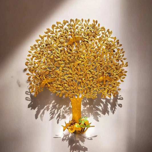 Brass Kalpvriksha centerpiece styled with indoor plants and soft ambient lighting