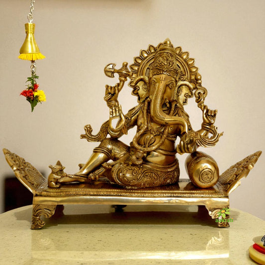 Sitting Lord Ganesha on a decorated throne brass made statue by Aakrati